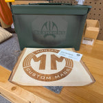 My Store custom laser engraved green metal ammo can with Seahawks logo displayed next to a branded wood sign